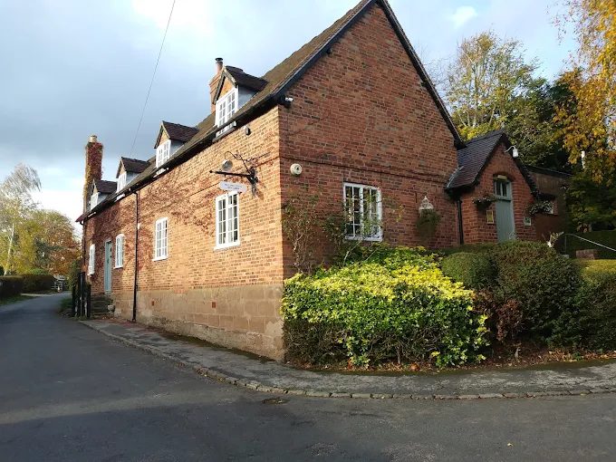 The club building in autumn light, seen from the lane